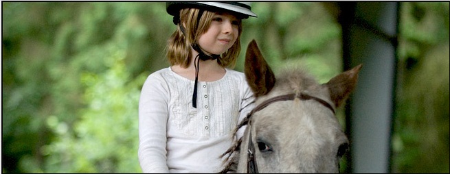 A young girl ready to ride