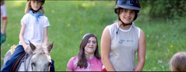 A young girl in the saddle